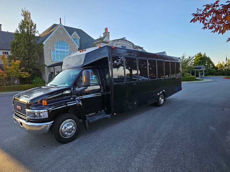 King XIII sleek black 34-passenger party bus exterior — premium luxury bus with black diamond quilted leather