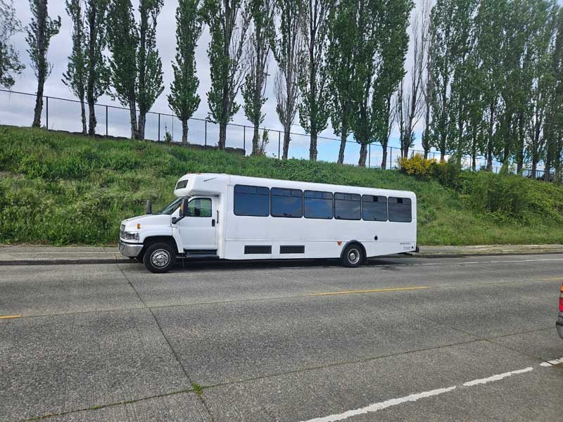 Kloud 9 white luxury party bus exterior — 34 passenger Seattle rental for weddings, corporate, and refined events